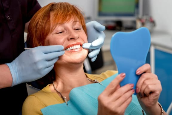 A dental provider speaking with a patient