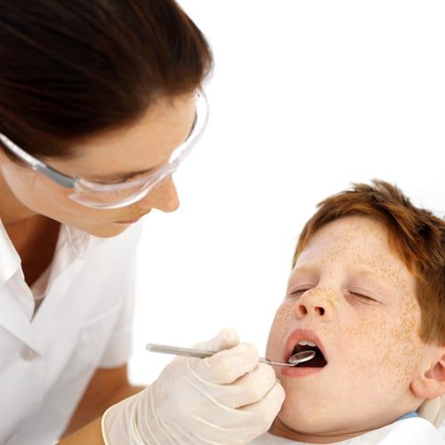 Dentist examining a child’s tooth