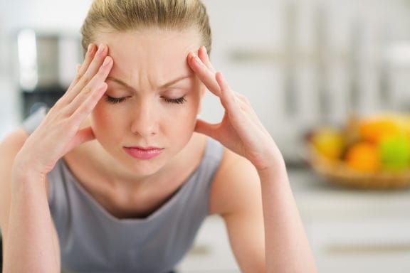 Woman experiencing symptoms associated with TMD